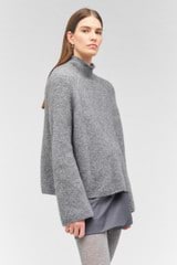 Profile view of model wearing the Oroton Soft Roll Knit in Charcoal and 16% mohair, 42% wool, 40% nylon, 2 % spandex for Women
