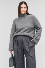 Profile view of model wearing the Oroton Soft Roll Knit in Charcoal and 16% mohair, 42% wool, 40% nylon, 2 % spandex for Women