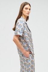 Profile view of model wearing the Oroton Zig Zag Flower Stamp Camp Shirt in Folk Blue and 100% silk for Women