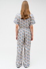 Profile view of model wearing the Oroton Zig Zag Flower Stamp PJ Pant in Folk Blue and 100% silk for Women