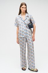 Profile view of model wearing the Oroton Zig Zag Flower Stamp PJ Pant in Folk Blue and 100% silk for Women