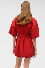 Profile view of model wearing the Oroton Fringe Detail Dress in Poppy and 100% cotton for Women