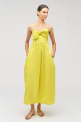 Profile view of model wearing the Oroton Lace Trim Sundress in Vibrant Yellow and 100% cotton for Women