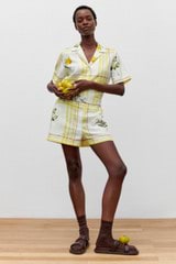 Profile view of model wearing the Oroton Summer Picnic Short in Vibrant Yellow and 100% linen for Women