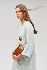 Profile view of model wearing the Oroton Embroidered Tunic Dress in Eau De Nil and 100% linen for Women