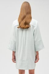 Profile view of model wearing the Oroton Embroidered Tunic Dress in Eau De Nil and 100% linen for Women