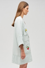 Profile view of model wearing the Oroton Embroidered Tunic Dress in Eau De Nil and 100% linen for Women