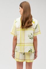 Profile view of model wearing the Oroton Summer Picnic Camp Shirt in Vibrant Yellow and 100% linen for Women