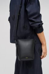 Profile view of model wearing the Oroton Ellis Crossbody in Black and Smooth leather for Women