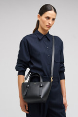 Profile view of model wearing the Oroton Ellis Small Tote in Black and Smooth leather for Women