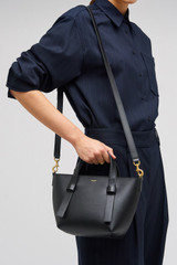 Profile view of model wearing the Oroton Ellis Small Tote in Black and Smooth leather for Women