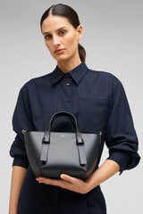 Profile view of model wearing the Oroton Ellis Small Tote in Black and Smooth leather for Women