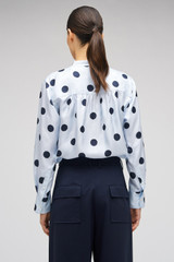 Profile view of model wearing the Oroton Starburst Spot Top in Glacier and 100% SILK for Women