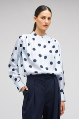 Profile view of model wearing the Oroton Starburst Spot Top in Glacier and 100% SILK for Women