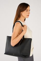 Profile view of model wearing the Oroton Dylan Large Tote in Black and Pebble leather for Women