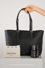 Profile view of model wearing the Oroton Dylan Large Tote in Black and Pebble leather for Women