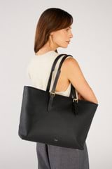 Profile view of model wearing the Oroton Dylan Large Tote in Black and Pebble leather for Women