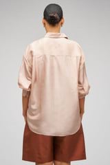 Profile view of model wearing the Oroton Ls Silk Shirt in Pale Rosewood and 100% Silk for Women