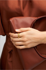 Profile view of model wearing the Oroton Ribbon Ring in Gold and  for Women