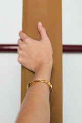 Profile view of model wearing the Oroton Ribbon Bangle in Gold and  for Women