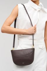 Profile view of model wearing the Oroton Florence Crossbody in Mahogany and  for Women