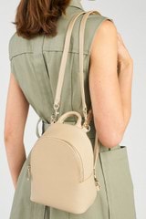 Profile view of model wearing the Oroton Inez Mini Backpack in Fawn and  for Women