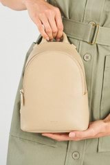 Profile view of model wearing the Oroton Inez Mini Backpack in Fawn and  for Women