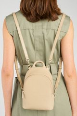 Profile view of model wearing the Oroton Inez Mini Backpack in Fawn and  for Women