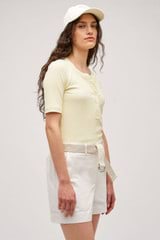 Profile view of model wearing the  Margot Rib Henley in Lemon and 92% Cotton / 8% Spandex for Men