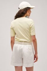 Profile view of model wearing the  Margot Rib Henley in Lemon and 92% Cotton / 8% Spandex for Men