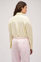 Profile view of model wearing the Oroton Wren Poplin Shirt in Lemon and Made from 100% poplin cotton  for Women