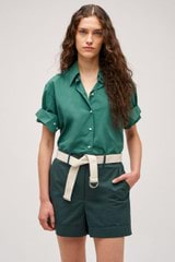 Profile view of model wearing the Oroton Wren Poplin Shirt in Villa Green and Made from 100% poplin cotton  for Women