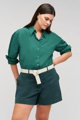 Profile view of model wearing the Oroton Wren Poplin Shirt in Villa Green and Made from 100% poplin cotton  for Women