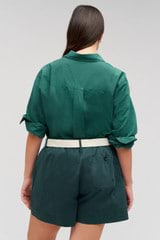 Profile view of model wearing the Oroton Wren Poplin Shirt in Villa Green and Made from 100% poplin cotton  for Women