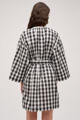 Profile view of model wearing the  Gingham Popover Dress in Black and High-quality fabric woven in Japan  for Men