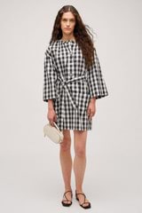 Profile view of model wearing the  Gingham Popover Dress in Black and High-quality fabric woven in Japan  for Men