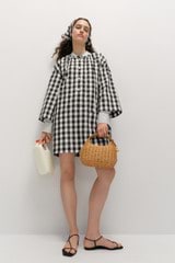 Profile view of model wearing the  Gingham Popover Dress in Black and High-quality fabric woven in Japan  for Men