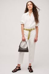 Profile view of model wearing the Oroton Wren Poplin Shirt in Antique White and Made from 100% poplin cotton  for Women