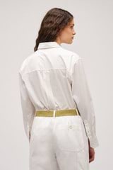 Profile view of model wearing the Oroton Wren Poplin Shirt in Antique White and Made from 100% poplin cotton  for Women