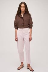 Profile view of model wearing the Oroton Arlo Carpenter Chino in Palest Pink and 100% Cotton for Women