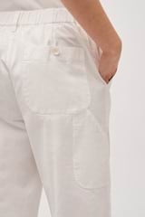 Profile view of model wearing the Oroton Arlo Carpenter Chino in Antique White and 100% Cotton for Women