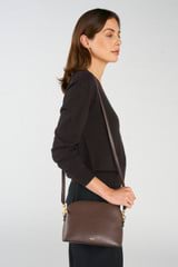 Profile view of model wearing the Oroton Inez Slim Crossbody in Coffee Bean and Shiny Soft Saffiano exterior for Women