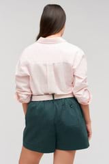 Profile view of model wearing the Oroton Wren Poplin Shirt in Palest Pink and Made from 100%  Cotton Poplin for Women