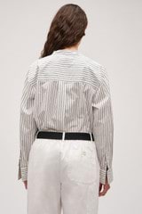 Profile view of model wearing the  Duo Stripe Shirt in Black and 100% Cotton for Women