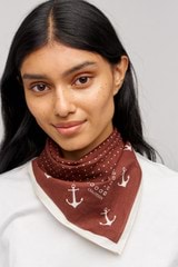 Profile view of model wearing the Oroton Mini Dot Cotton Bandana in Chocolate and Made from 100% cotton voile  for Women