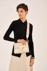 Profile view of model wearing the Oroton Logo Bag Strap in  and Smooth Leather And Webbing for Women