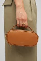 Profile view of model wearing the Oroton Margot Camera Bag in Dark Camel and Smooth Leather for Women