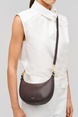 Profile view of model wearing the Oroton Florence Small Shoulder Bag in Mahogany and  for Women