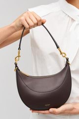 Profile view of model wearing the Oroton Florence Small Shoulder Bag in Mahogany and  for Women