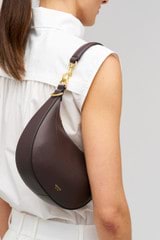 Profile view of model wearing the Oroton Florence Small Shoulder Bag in Mahogany and  for Women